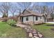 Charming home with stone chimney, stone walkway, and landscaped front yard at 1234 E 71St St, Indianapolis, IN 46220