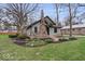 Charming home with stone chimney and landscaped front yard at 1234 E 71St St, Indianapolis, IN 46220