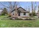 Charming home with stone chimney and landscaped front yard at 1234 E 71St St, Indianapolis, IN 46220