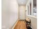 Light-filled hallway features hardwood floors, a bench with pillows, and a view of the outdoors through the window at 1234 E 71St St, Indianapolis, IN 46220