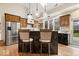 Stylish kitchen with a breakfast bar, stainless steel refrigerator, modern lighting, and natural wood accents at 1234 E 71St St, Indianapolis, IN 46220