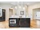 Bright kitchen island boasts quartz countertops, sink, microwave, and stylish pendant lights at 1234 E 71St St, Indianapolis, IN 46220