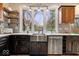 Charming kitchen featuring stainless steel appliances, a farmhouse sink, and stylish wood shelving at 1234 E 71St St, Indianapolis, IN 46220