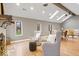 Bright living room featuring vaulted ceiling, skylights, fireplace, and hardwood floors at 1234 E 71St St, Indianapolis, IN 46220