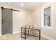 Home office featuring a modern barn door, stylish desk, chair, and natural light at 1234 E 71St St, Indianapolis, IN 46220