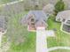 Aerial view of a brick home with a large driveway and a well-manicured lawn at 130 George Ct, Danville, IN 46122