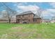 Expansive backyard with a brick house and a deck featuring an outdoor seating area at 130 George Ct, Danville, IN 46122