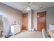 A secondary bedroom with a ceiling fan, closet, and a dresser at 130 George Ct, Danville, IN 46122