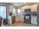 Inviting kitchen features granite countertops, stainless appliances, and corner windows for natural light at 130 George Ct, Danville, IN 46122