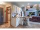 An open-concept kitchen with granite countertops, a breakfast bar, and access to the living room at 130 George Ct, Danville, IN 46122