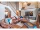 Spacious living room with a soaring ceiling, brick fireplace, comfortable leather seating, and staircase at 130 George Ct, Danville, IN 46122