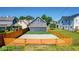 The spacious backyard has gravel, grass, and an orange horizontal wooden fence for privacy at 1321 Union St, Indianapolis, IN 46225