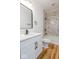 Bathroom with modern vanity, decorative mirror, and tiled shower at 1321 Union St, Indianapolis, IN 46225