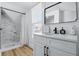 Well-lit bathroom showcases a marble-tiled shower, vanity with modern fixtures, and a bright window, creating a luxurious feel at 1321 Union St, Indianapolis, IN 46225
