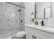 Modern bathroom featuring black hardware, a shower with marble-patterned tiles, and bright countertops at 1321 Union St, Indianapolis, IN 46225