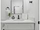 Stylish bathroom features black hardware, bright countertops and a framed mirror at 1321 Union St, Indianapolis, IN 46225