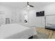 A bright bedroom features a ceiling fan, flat screen TV and bright hardwood floors at 1321 Union St, Indianapolis, IN 46225