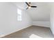 Attic bedroom with neutral carpet, white walls and a ceiling fan at 1321 Union St, Indianapolis, IN 46225