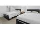 Bright bedroom features two beds with a small wooden nightstand creating a practical and inviting shared space at 1321 Union St, Indianapolis, IN 46225