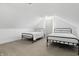 Bright bedroom featuring two twin beds, neutral carpet, and sloped ceilings providing a cozy and inviting space at 1321 Union St, Indianapolis, IN 46225