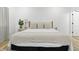 Bright bedroom featuring a plush bed with stylish throw pillows and light hardwood floors at 1321 Union St, Indianapolis, IN 46225
