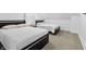 Cozy bedroom featuring two twin beds, neutral carpet, and black frame beddings that provides a comfortable, shared space at 1321 Union St, Indianapolis, IN 46225