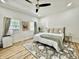 Bright bedroom featuring a queen bed, neutral decor, and a ceiling fan at 1321 Union St, Indianapolis, IN 46225