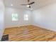 Bedroom with ceiling fan, wood floors, and two bright windows at 1321 Union St, Indianapolis, IN 46225