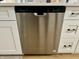 Stainless steel dishwasher integrated in white kitchen cabinetry with sleek handles at 1321 Union St, Indianapolis, IN 46225