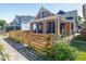 Charming two-story home with a new wooden fence, manicured lawn, and colorful exterior paint at 1321 Union St, Indianapolis, IN 46225