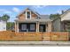 Charming two-story home featuring a unique color scheme and a well-maintained fenced yard at 1321 Union St, Indianapolis, IN 46225