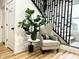 Cozy chair and plant in the foyer with a modern staircase at 1321 Union St, Indianapolis, IN 46225