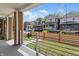 View of street and front yards from the covered porch with painted support beams at 1321 Union St, Indianapolis, IN 46225