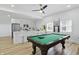 Bright game room featuring a billiards table, sleek bar with white cabinets, and game machine at 1321 Union St, Indianapolis, IN 46225