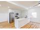 Bright, modern kitchen with stainless steel appliances, white cabinets and countertops, and wood flooring at 1321 Union St, Indianapolis, IN 46225
