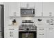 Bright kitchen features white cabinets, modern appliances, and attractive gold hardware at 1321 Union St, Indianapolis, IN 46225