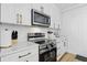 Updated kitchen features stainless steel appliances, stylish backsplash, and ample counter space at 1321 Union St, Indianapolis, IN 46225