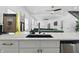 Stylish wet bar featuring white cabinets and stainless appliances with game room views at 1321 Union St, Indianapolis, IN 46225