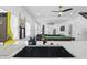 Sleek wet bar featuring white cabinets and stainless appliances overlooking the game room at 1321 Union St, Indianapolis, IN 46225