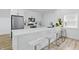 Contemporary kitchenette with white cabinets, stainless appliances, and bar seating at 1321 Union St, Indianapolis, IN 46225