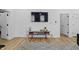 Bright living room is open to doorways, hardwood floors, and a large TV at 1321 Union St, Indianapolis, IN 46225