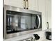 Stainless steel microwave above stove with modern white cabinetry at 1321 Union St, Indianapolis, IN 46225