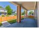 Inviting front porch featuring sturdy columns, a concrete floor, and a new orange horizontal wooden fence at 1321 Union St, Indianapolis, IN 46225