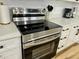 Stainless steel stove in a modern kitchen with white cabinets and speckled countertops at 1321 Union St, Indianapolis, IN 46225