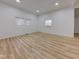 A bright bedroom with hardwood floors, three windows, and white walls at 1360 N Dearborn St, Indianapolis, IN 46201