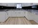 Chic kitchen boasting white cabinetry, granite countertops, and sleek black hardware for a modern aesthetic at 1360 N Dearborn St, Indianapolis, IN 46201