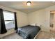 Neutral bedroom with large window featuring carpeted floors and a bed with black accents at 1380 Delacorte Cir, Shelbyville, IN 46176