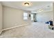 Spacious bonus room featuring plush carpet, neutral colors, and bright windows for plenty of natural light at 1380 Delacorte Cir, Shelbyville, IN 46176