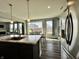 Open concept dining area with modern fixtures and stainless steel appliances, flowing to the living room at 1380 Delacorte Cir, Shelbyville, IN 46176