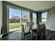 Bright dining area featuring a sliding glass door and modern farmhouse style table and chairs at 1380 Delacorte Cir, Shelbyville, IN 46176